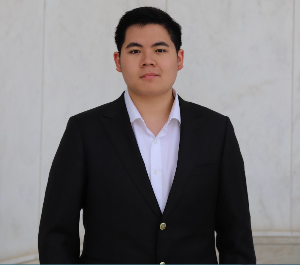 Portrait of Ching-Wei Kang in a black suit